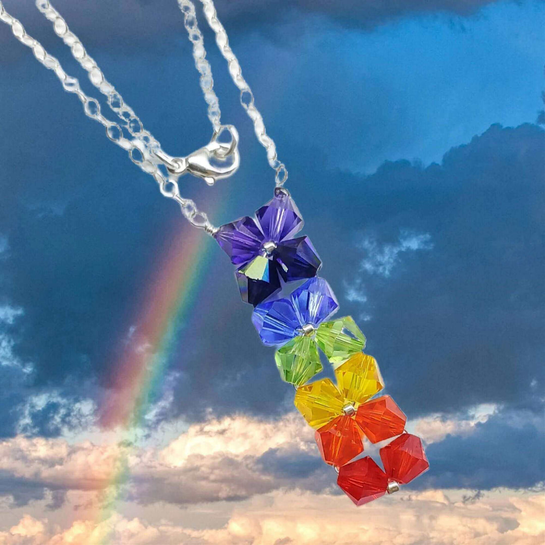 Do You Know What The Colors Of The Rainbow Mean - colorful necklace against a rainbow backdrop