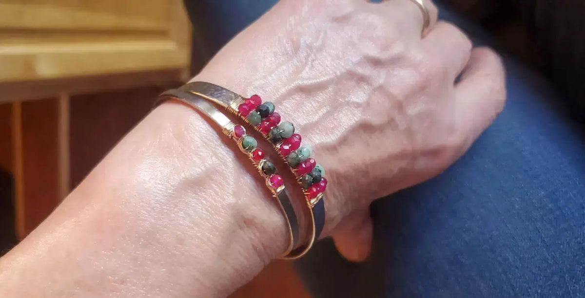 Close-up of a hand wearing a decorative bracelet, illustrating the importance of choosing metals and designs carefully.