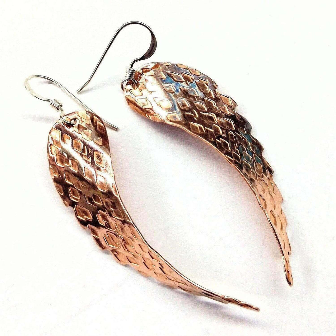 Warm rose gold color of copper earrings with a unique textured design.
