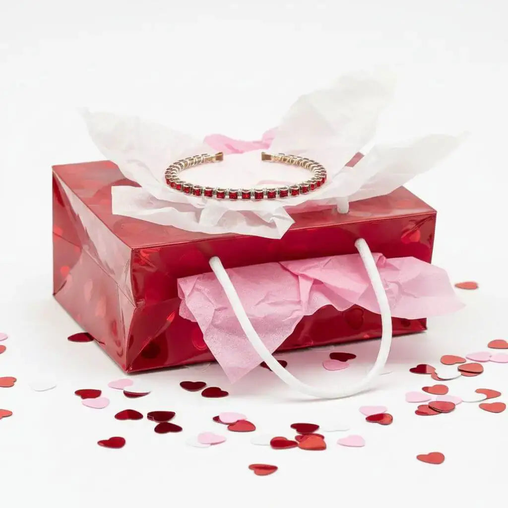 Red Crystal Bangles Are This Season's Power Move displayed in a red gift box with heart-shaped confetti.