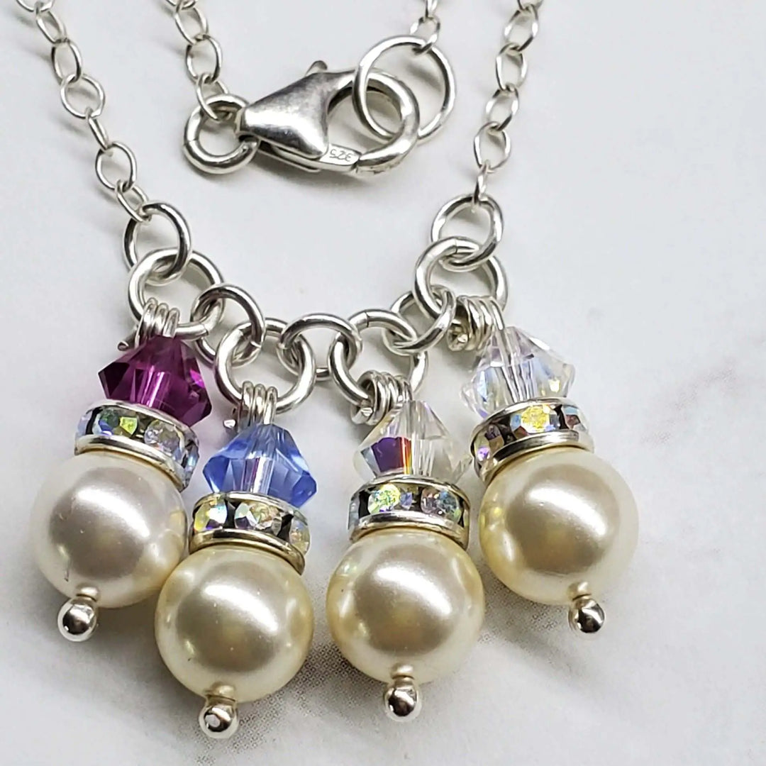 Handmade Birthstone Jewelry featuring pearls and colorful crystals on a silver chain necklace.