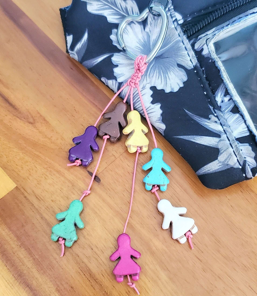 Colorful handmade jewelry with figurine charms representing diversity, part of Purposeful Handmade Fashion Jewelry collection.