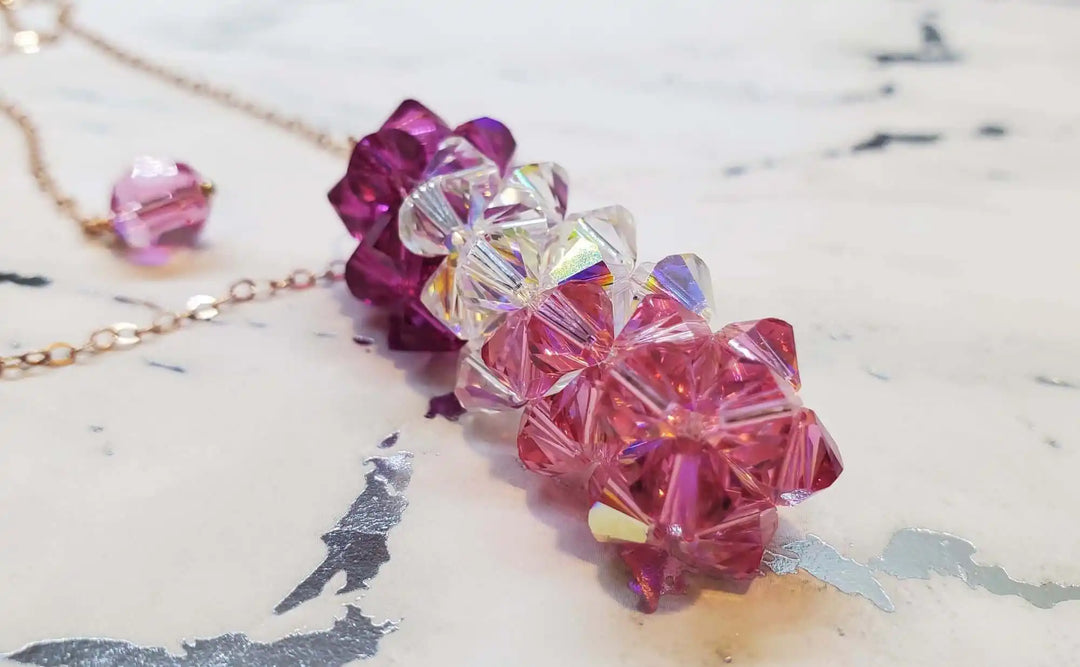 A Sparkly pillar of Mom necklace on marble background