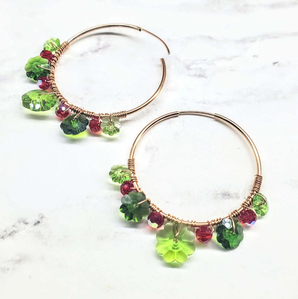 Handcrafted hoop earrings collection featuring vibrant green and red glass beads, artisan-made design by Alexa Martha.