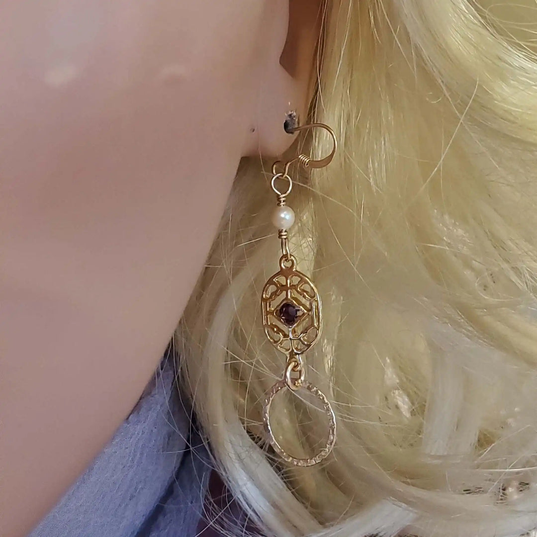 14 K Gold Filled Purple Crystal Circle Filigree Earrings worn on a mannequin model.
