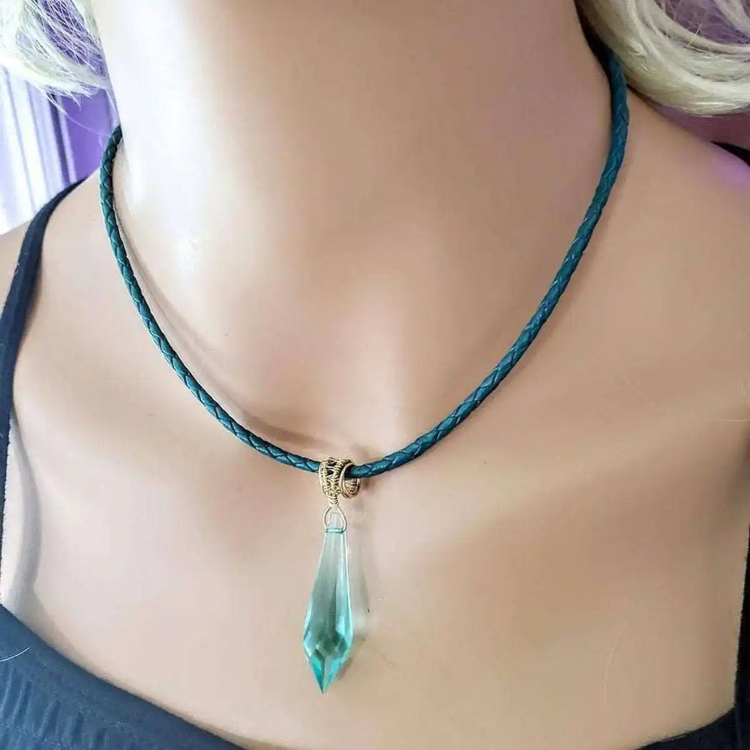 Gold filled aqua crystal choker necklace featuring a stunning aqua crystal pendant on a braided leather cord.