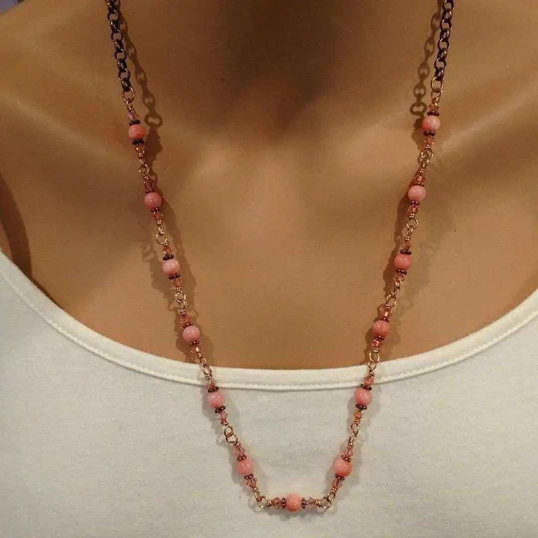 24-Inch Copper Peach Pearl Crystal Wire Wrapped Necklace displayed on a mannequin, featuring peach pearls and antiqued copper.