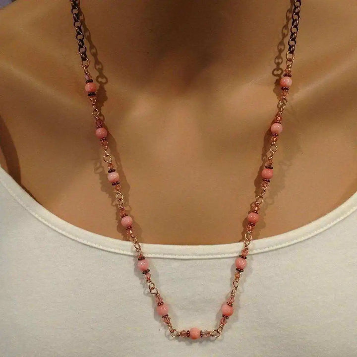 24-Inch Copper Peach Pearl Crystal Wire Wrapped Necklace displayed on a mannequin, featuring peach pearls and antiqued copper.