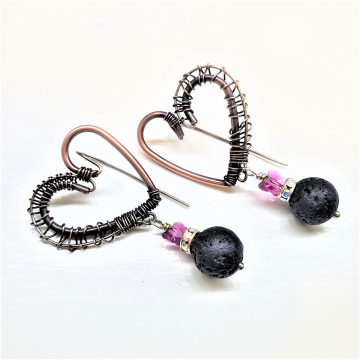 Copper Sculpted Heart Hoop Crystal Butterfly Lava Rock Earrings on a light background.
