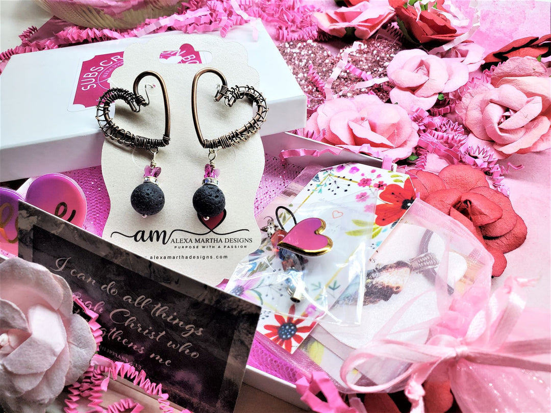 Copper Sculpted Heart Hoop Crystal Butterfly Lava Rock Earrings displayed with decorative packaging and flowers.