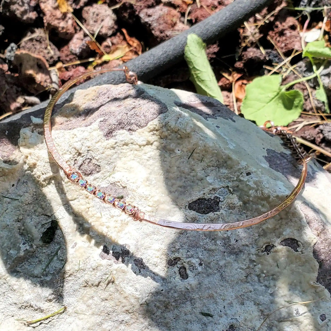 Handmade 7-year anniversary Copper Crystal Choker Set displayed on a rock surface outdoors.