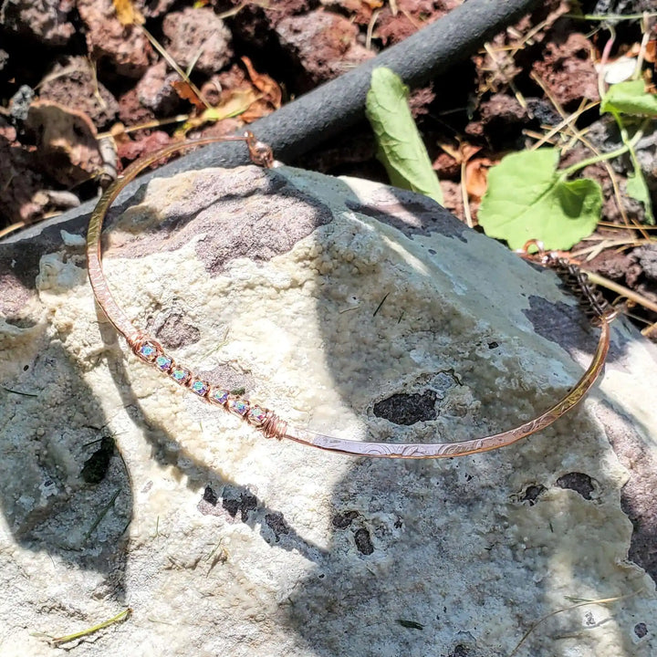 Handmade 7-year anniversary Copper Crystal Choker Set displayed on a rock surface outdoors.