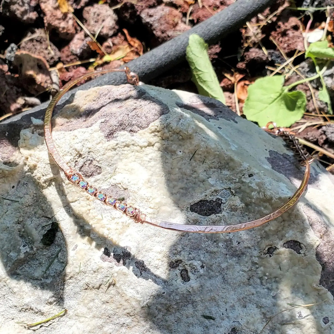 Handmade 7-year anniversary Copper Crystal Choker Set displayed on a rock surface outdoors.