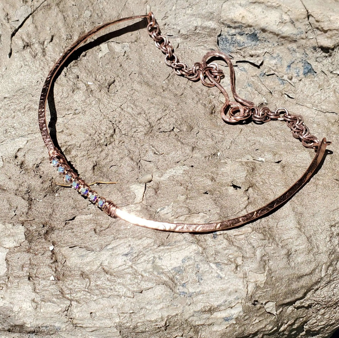 Handmade 7-year anniversary Copper Crystal Choker Set on a rock background with shiny crystals feature.