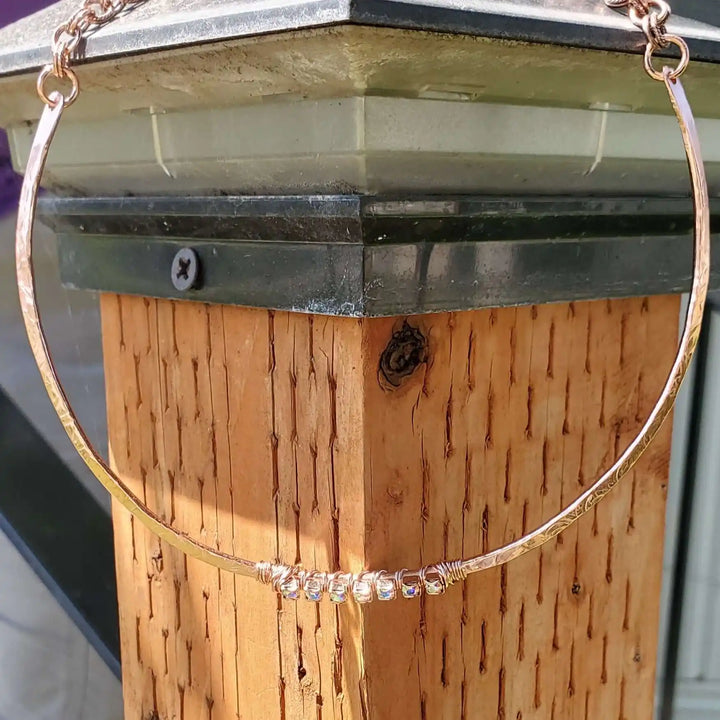 Handmade 7-year anniversary Copper Crystal Choker Set displayed on a wooden post, showcasing its unique design.
