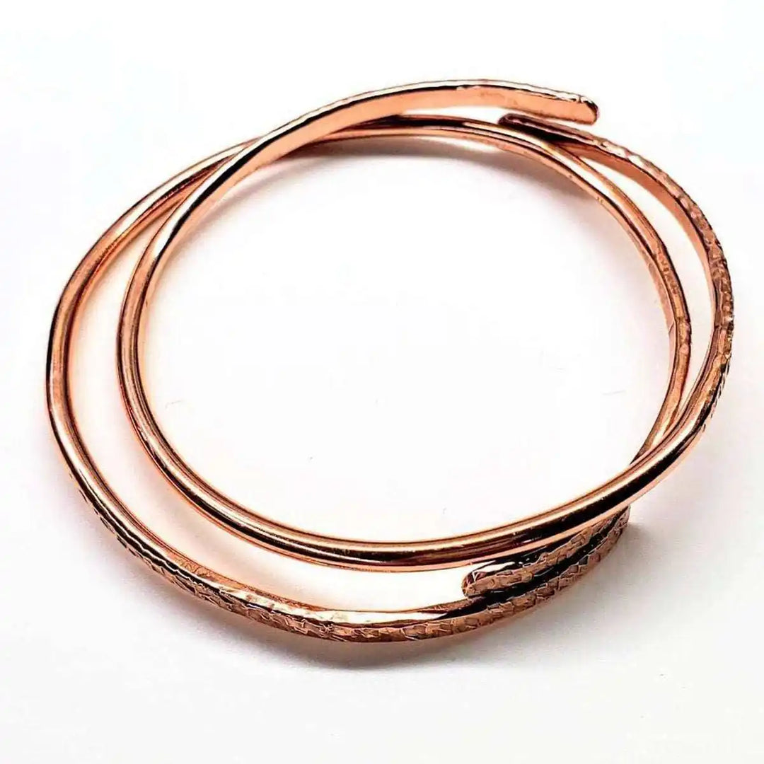 Unisex 8 Gauge Adjustable Hammered Copper Overlap Bangle showing its distinctive overlapping design and hammered texture.