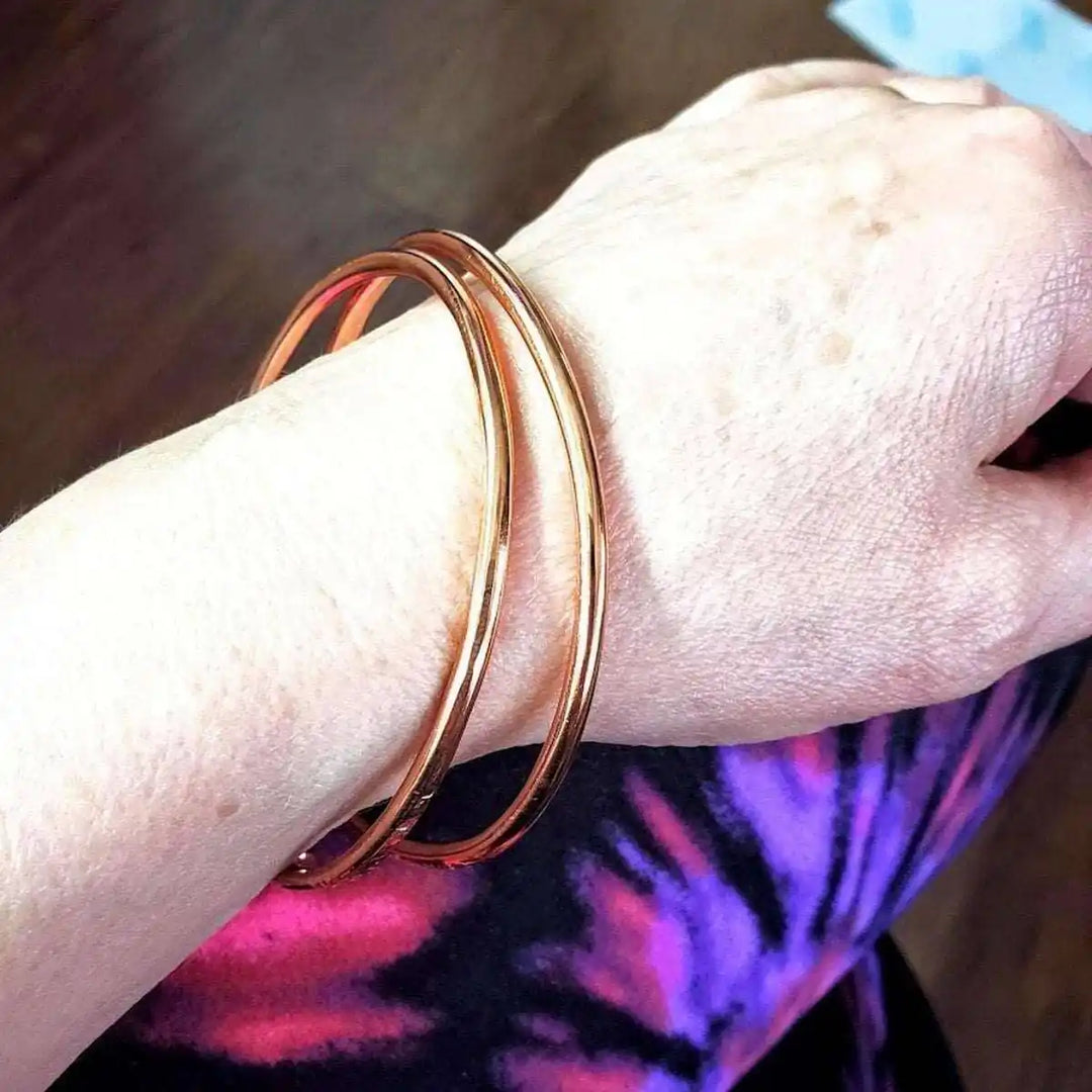 Unisex 8 Gauge Adjustable Hammered Copper Overlap Bangle displayed on a wrist, showcasing its bold design and craftsmanship.