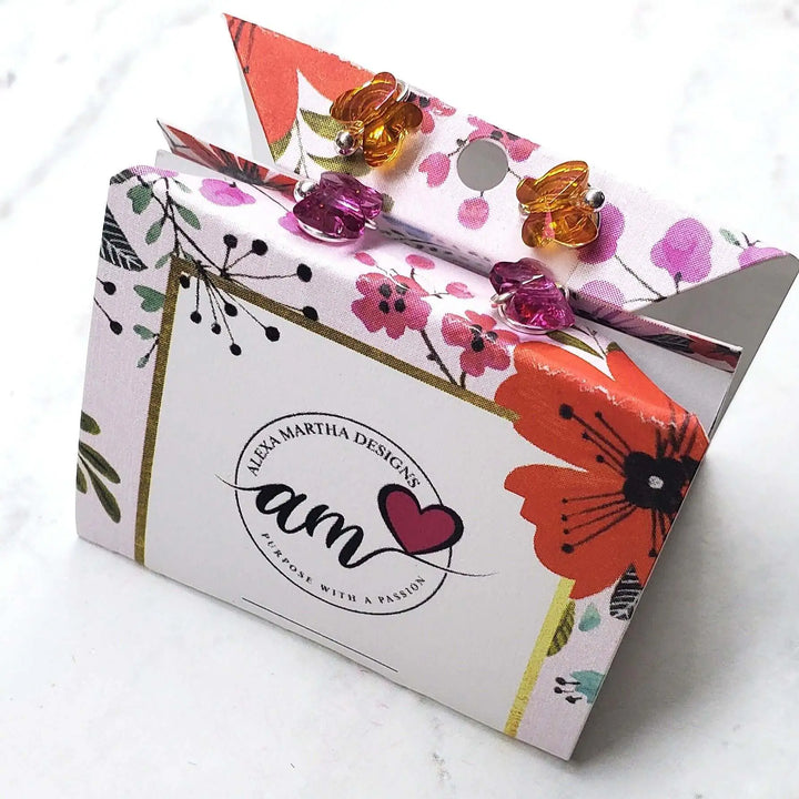 Colorful packaging for 5mm Spiral Butterfly Earring Studs by Alexa Martha Designs, featuring floral design and Swarovski crystals.