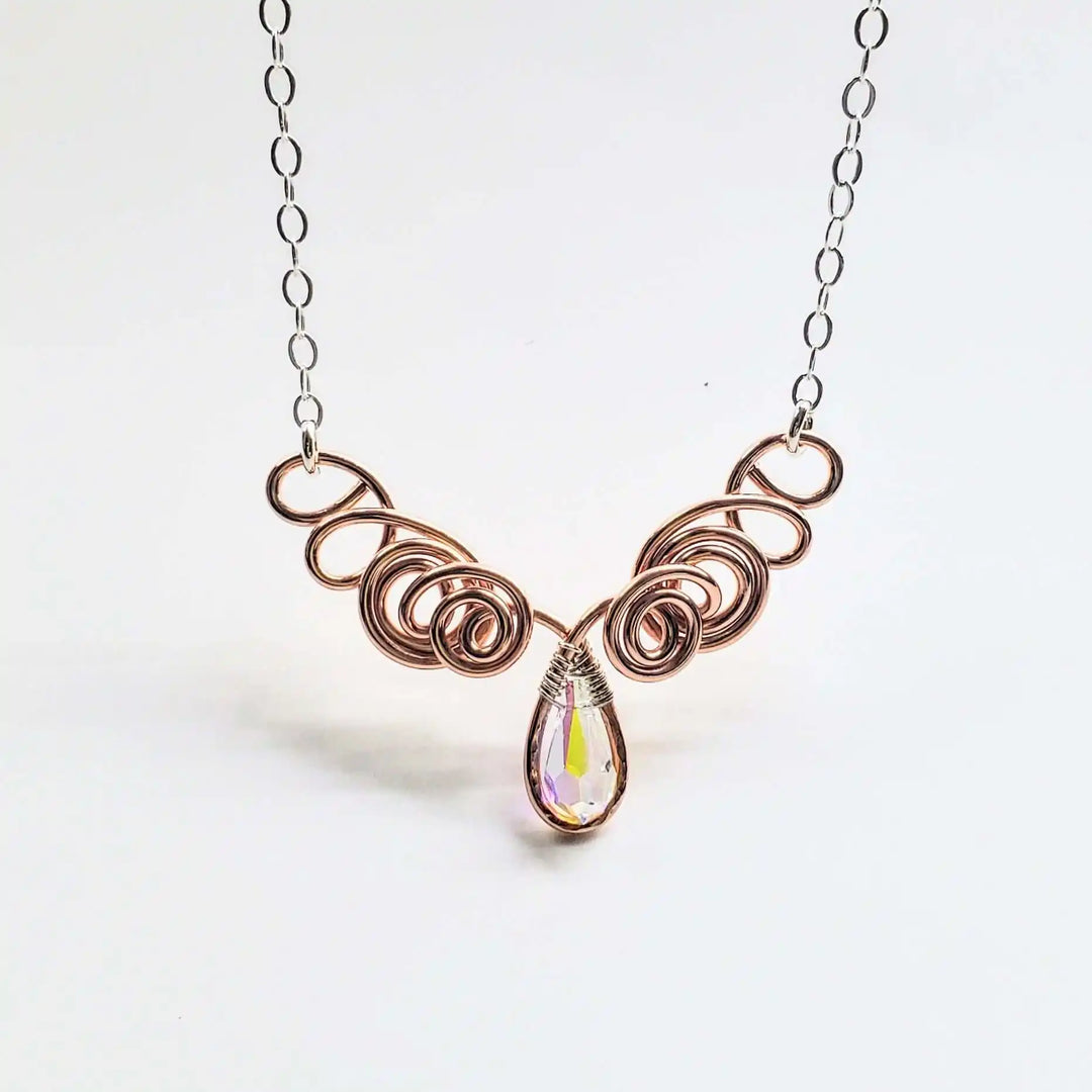 Handmade Sculpted Copper Silver Angel in Flight Necklace featuring intricate swirling design and a sparkling crystal drop.