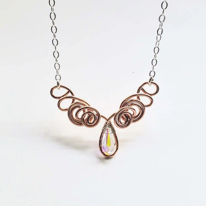 Handmade Sculpted Copper Silver Angel in Flight Necklace featuring intricate swirling design and a sparkling crystal drop.