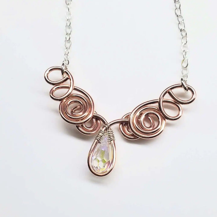 Handmade Sculpted Copper Silver Angel in Flight Necklace with intricate swirls and a shimmering teardrop gem.
