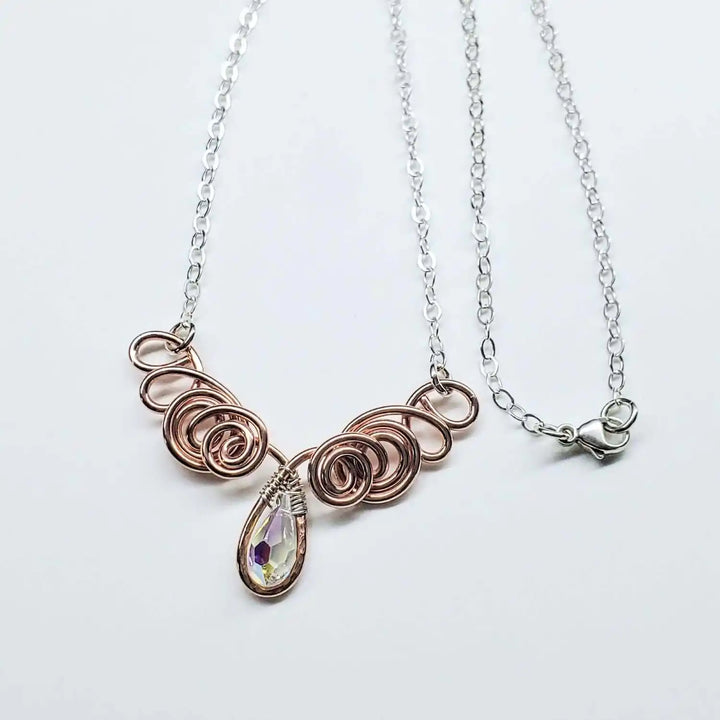 Handmade Sculpted Copper Silver Angel in Flight Necklace with intricate spiral design and crystal drop.