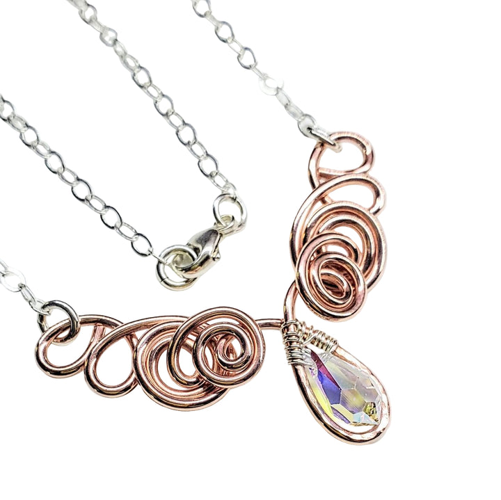 Necklace with rose gold loops and a teardrop-shaped gemstone on a white background