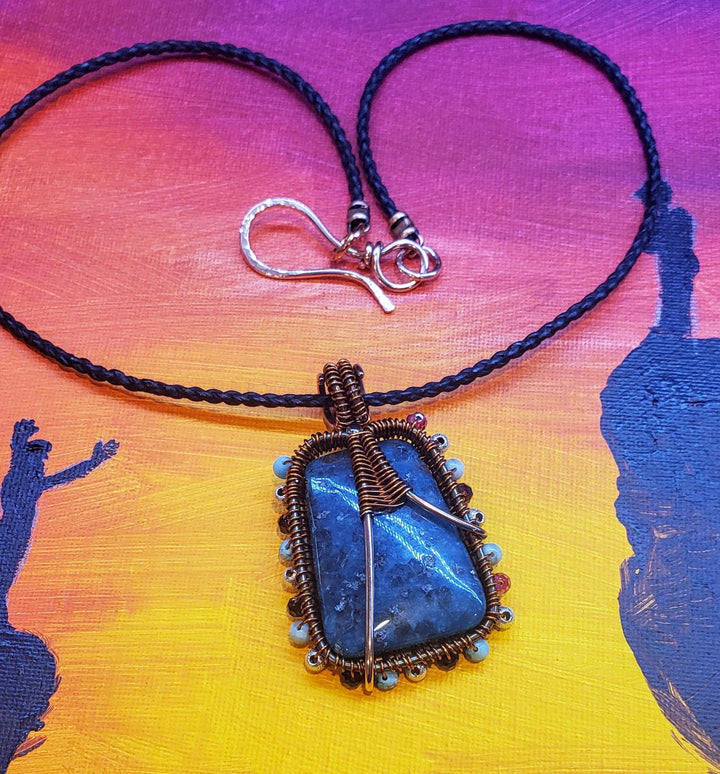 Necklace with a blue pendant on a colorful background