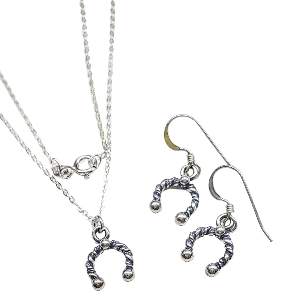 Handmade sterling silver horseshoe jewelry set, featuring necklace and earrings, perfect for good fortune and elegance.