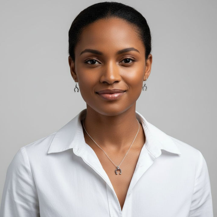 Woman wearing handmade sterling silver horseshoe jewelry, showcasing artisan elegance and charm.
