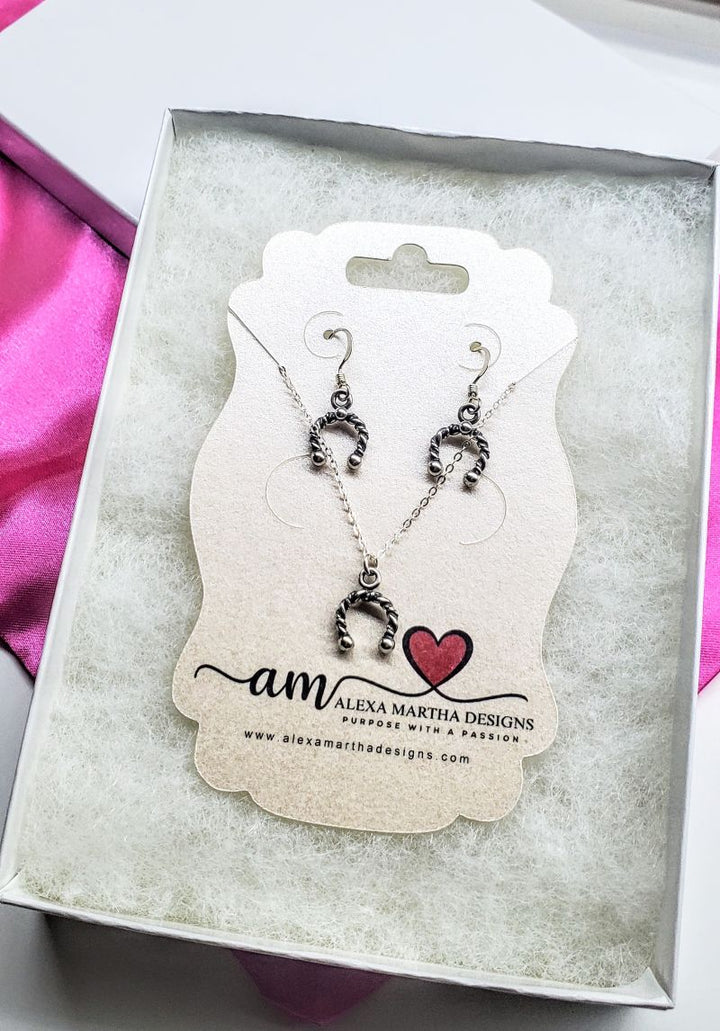 Handmade sterling silver horseshoe jewelry set displayed in a gift box with earrings and necklace.