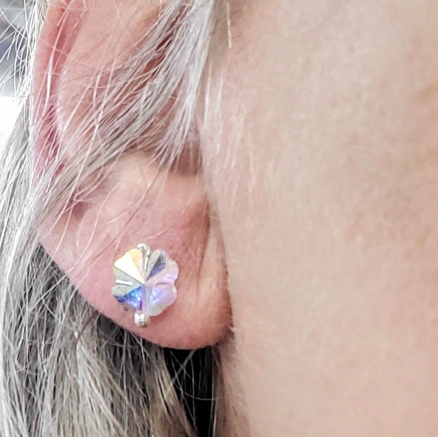 8mm Crystal Clover Silver Spiral Ear Studs worn by a model showcasing their sparkling design and craftsmanship.