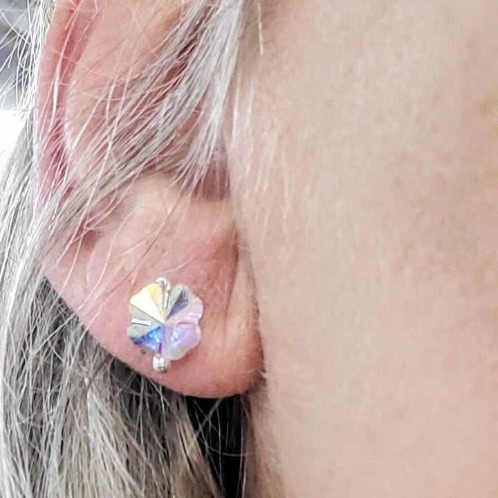 8mm Crystal Clover Silver Spiral Ear Studs worn by a model showcasing their sparkling design and craftsmanship.