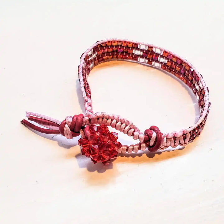 Leather Silk Bead Woven Crystal Button Bracelet featuring red leather and sparkling pink Swarovski crystals.