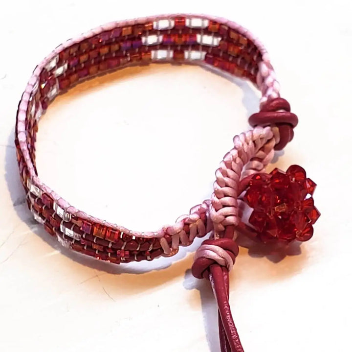 Leather Silk Bead Woven Crystal Button Bracelet with intricate bead-weaving and a red crystal button detail.