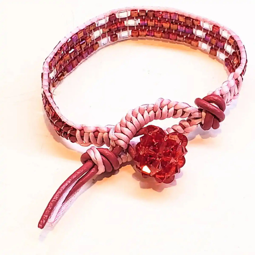 Leather Silk Bead Woven Crystal Button Bracelet featuring pink silk and a red crystal button.