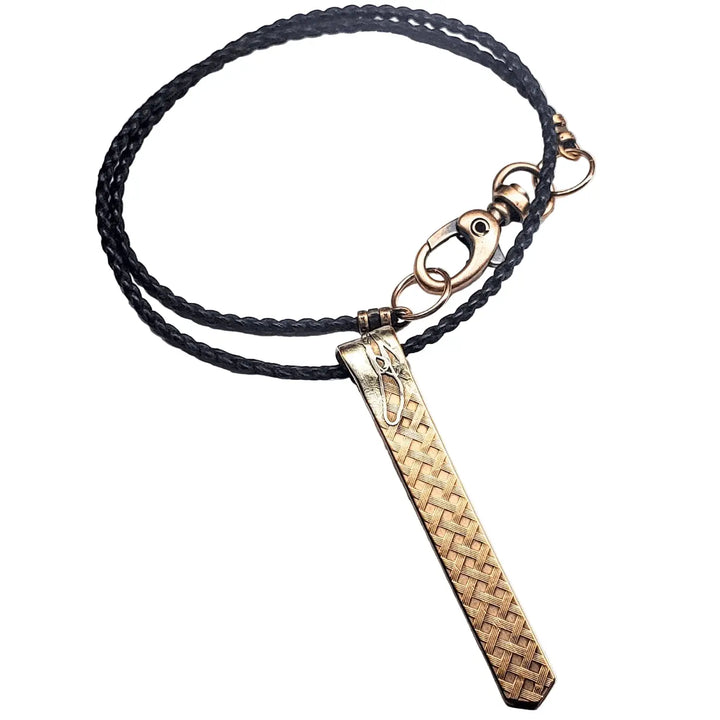 Copper Weave Embossed Necktie Necklace featuring a bold pendant and braided black cord.