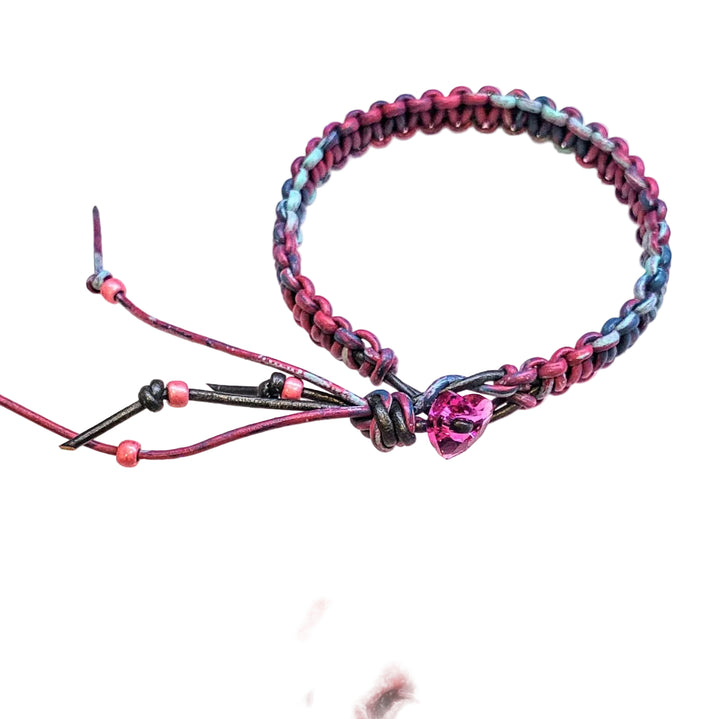 Macrame tie-dye leather Crystal bracelet featuring vibrant pink, blue, and black colors with a shining crystal detail.