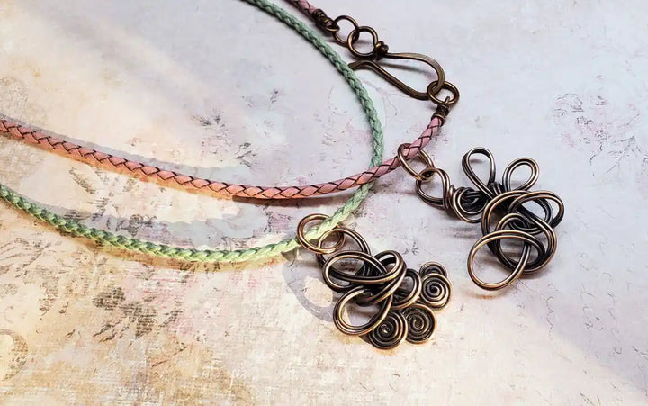 Reversible Interchangeable Copper Wire Sculpted Necklaces featuring intricate designs and colorful braided cords.