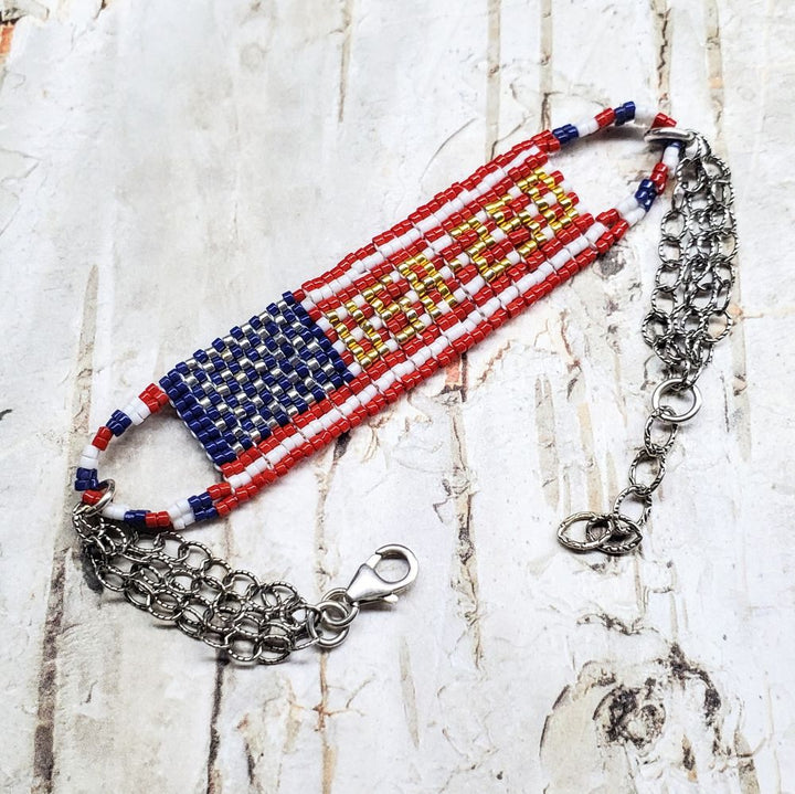 USA 250th Anniversary Beaded Bracelet By Alexa Martha featuring vibrant red, white, and blue beadwork in a unique design.