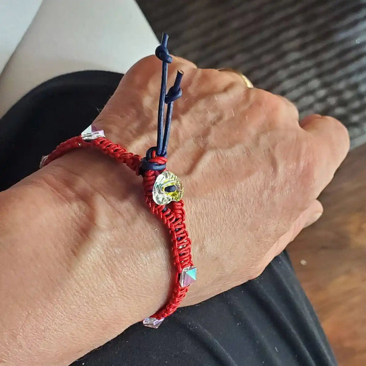 Red White and Blue Macrame Wire Wrap Crystal Spike Bracelet worn on wrist showcasing intricate macrame knotwork and crystal spikes.