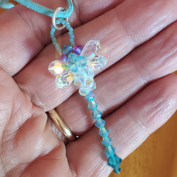 Beaded 3-D Rearview Mirror Colored Crystal Dragonfly Charm held in hand, showcasing teal and aquamarine Swarovski crystals.