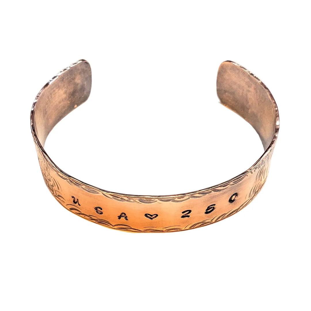 Copper bracelet with engraved USA 250 on a white background