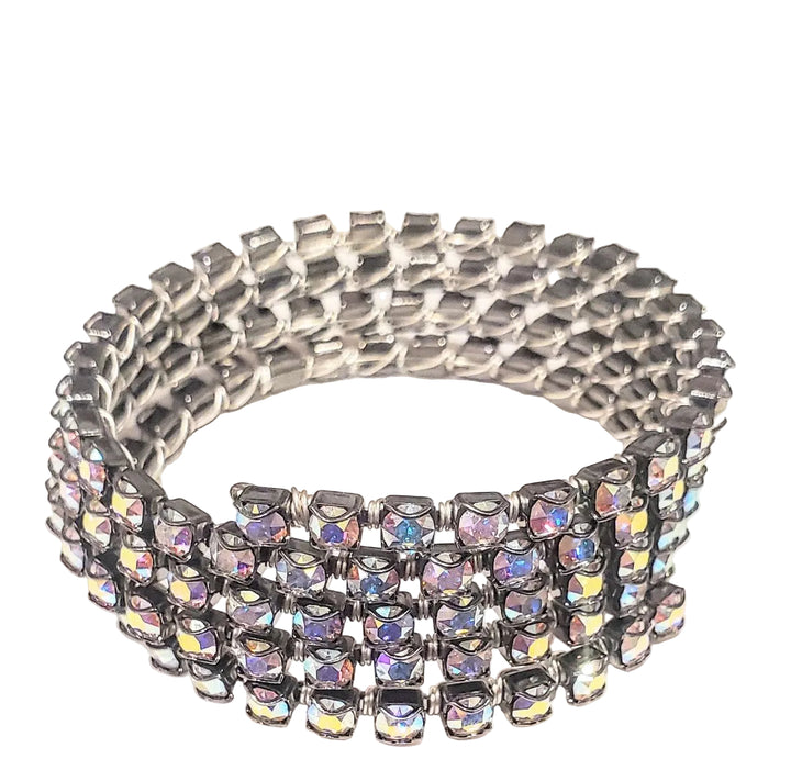 A silver-toned multi-row bracelet featuring square iridescent rhinestones that reflect a rainbow of colors, set against a plain off-white background.