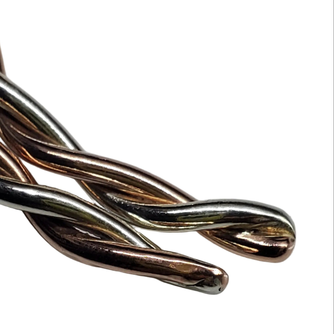 Close-up of intertwined 12-gauge copper and sterling silver wire on a handmade twisted cuff bracelet