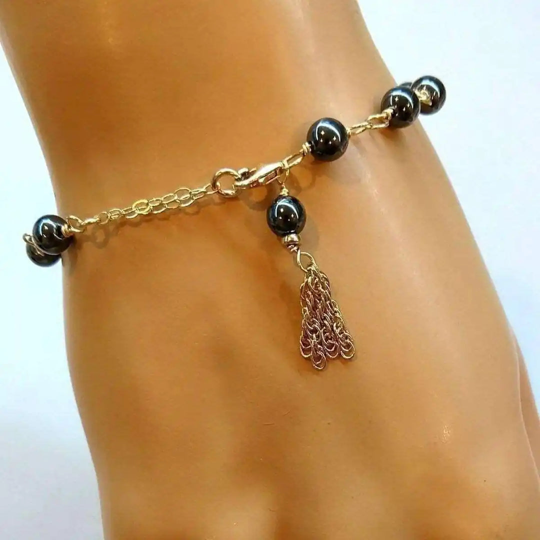 Adjustable 14 KT Gold Filled Hematite Chain Tassel Bracelet featuring hand wire-wrapped hematite beads.