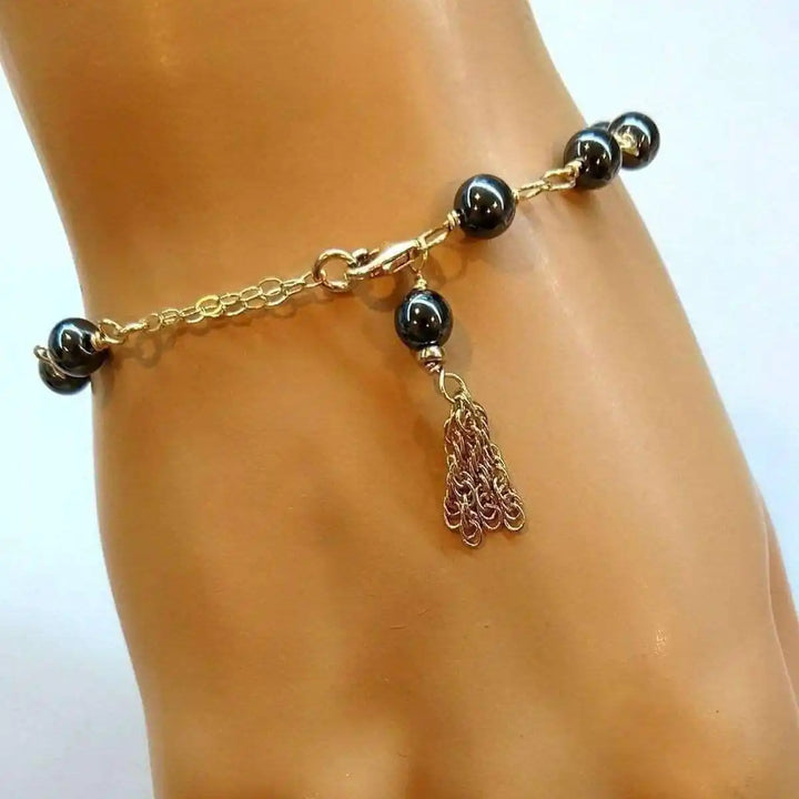 Adjustable 14 KT Gold Filled Hematite Chain Tassel Bracelet featuring hand wire-wrapped hematite beads.