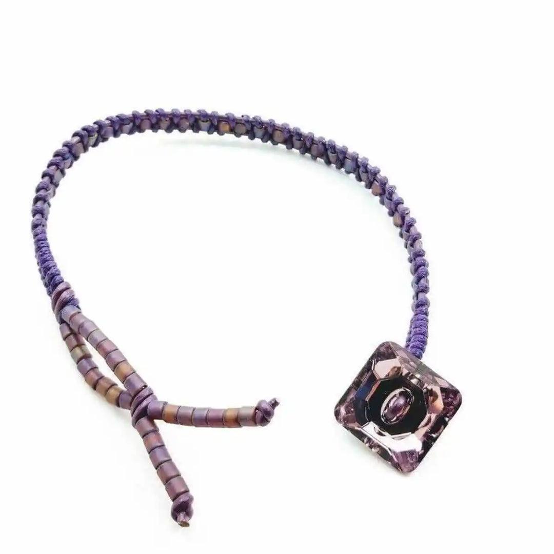 Amethyst Braided Leather Swarovski Crystal Button Bracelet showcasing a unique braided design with a stylish purple crystal button.