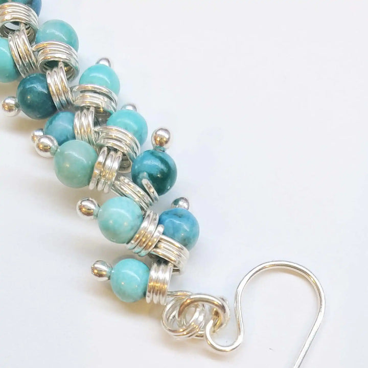 Seen On Jane The Virgin Silver Turquoise Wire Coil Earrings showcasing turquoise beads wrapped in silver wire.