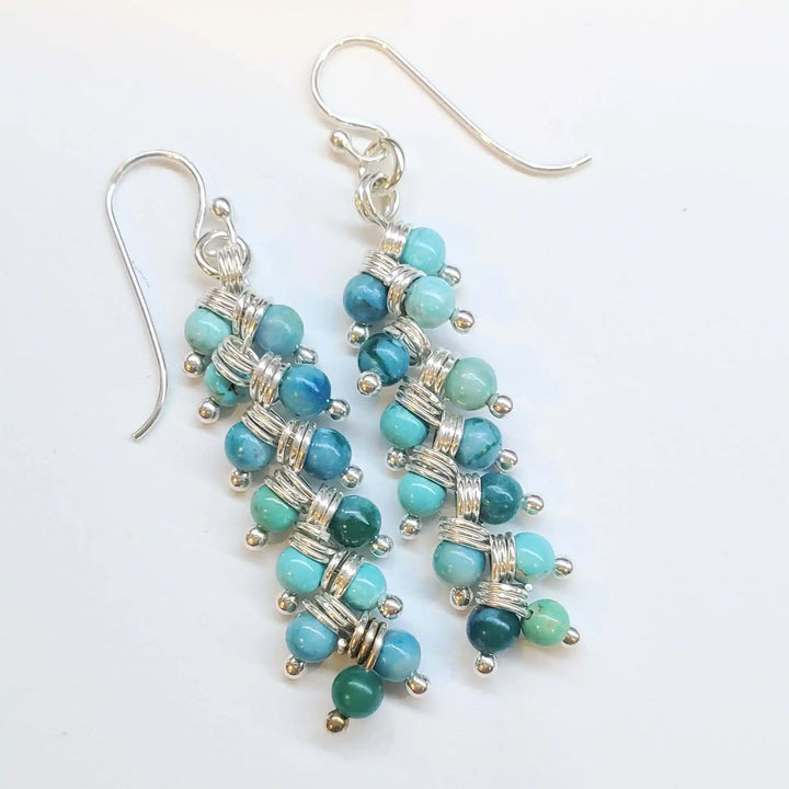 Seen On Jane The Virgin Silver Turquoise Wire Coil Earrings showcasing turquoise and silver colors.